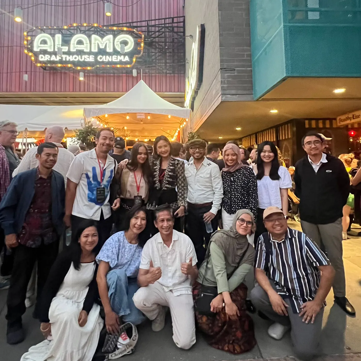Group photo outside a cinema at night
