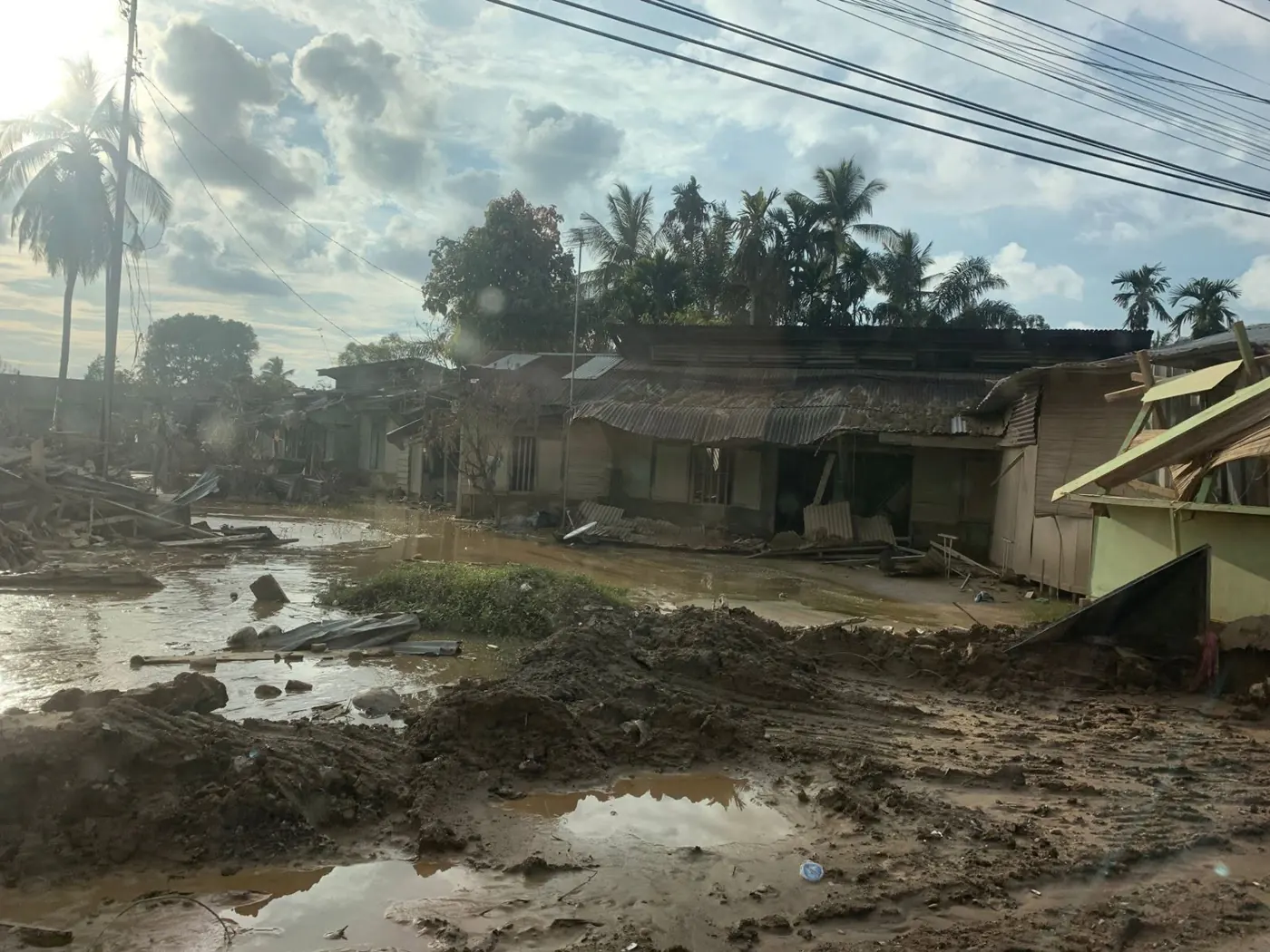 Houses damaged and covered in mud after the flood