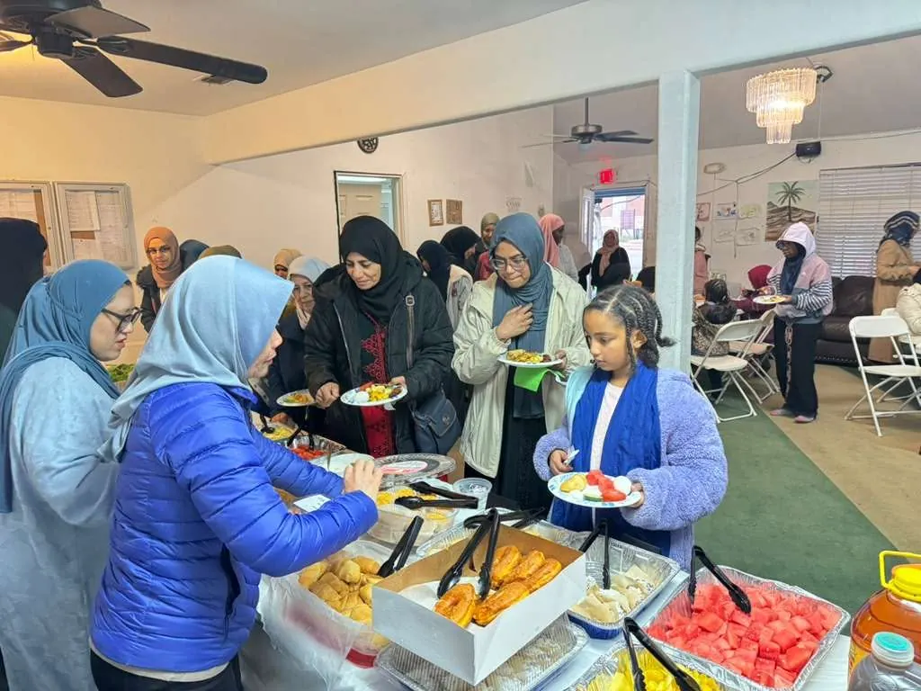 Sisters and kids at a buffet table filling their plates