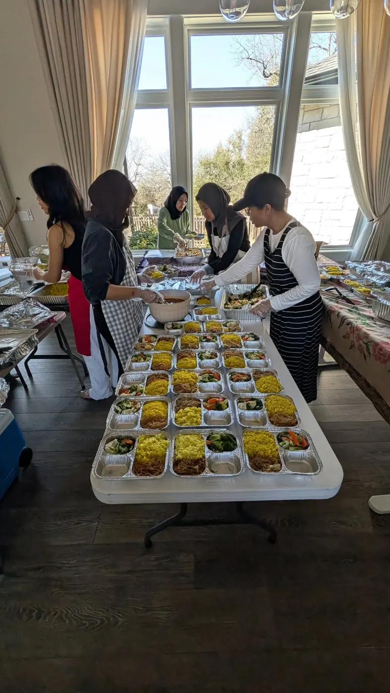 Rows of Indonesian meal boxes laid out on a long table