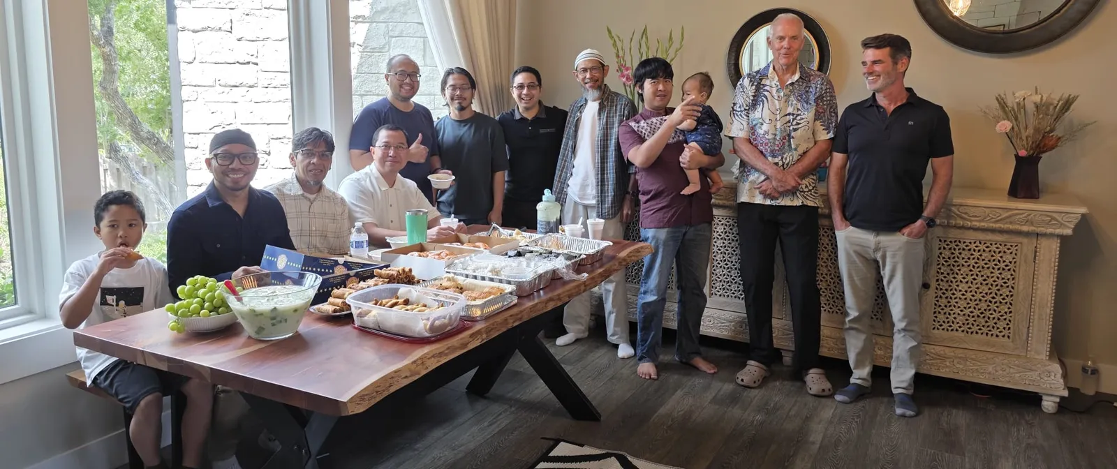 Bapak-bapak and kids of IMATX around a table of Indonesian food at the Family Halaqa in Lakeway, September 2026