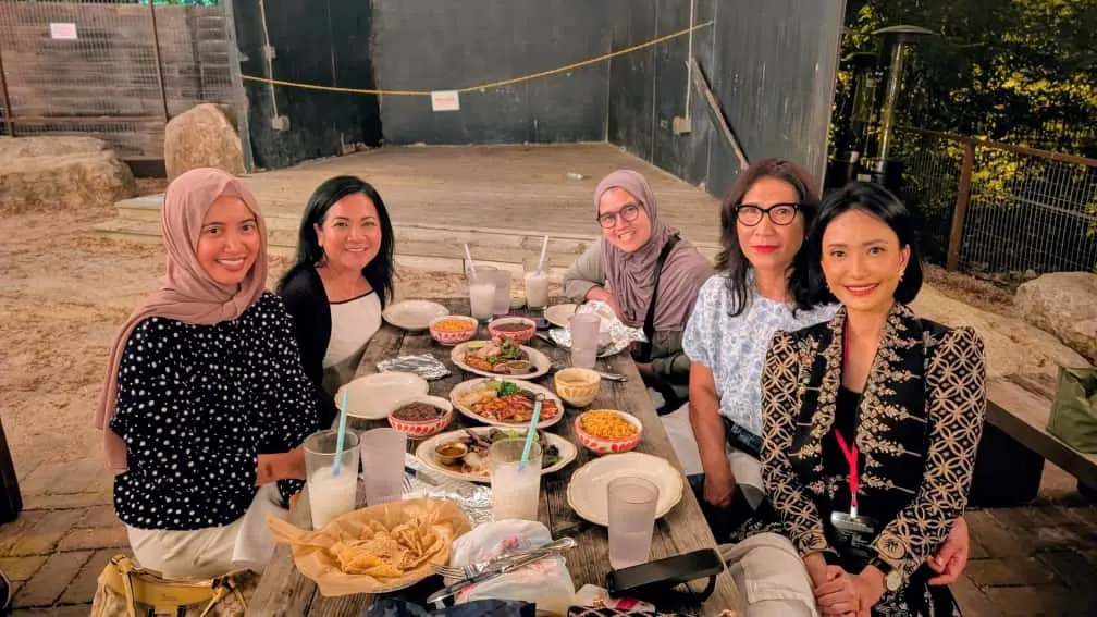 Sisters sharing a meal at an outdoor table