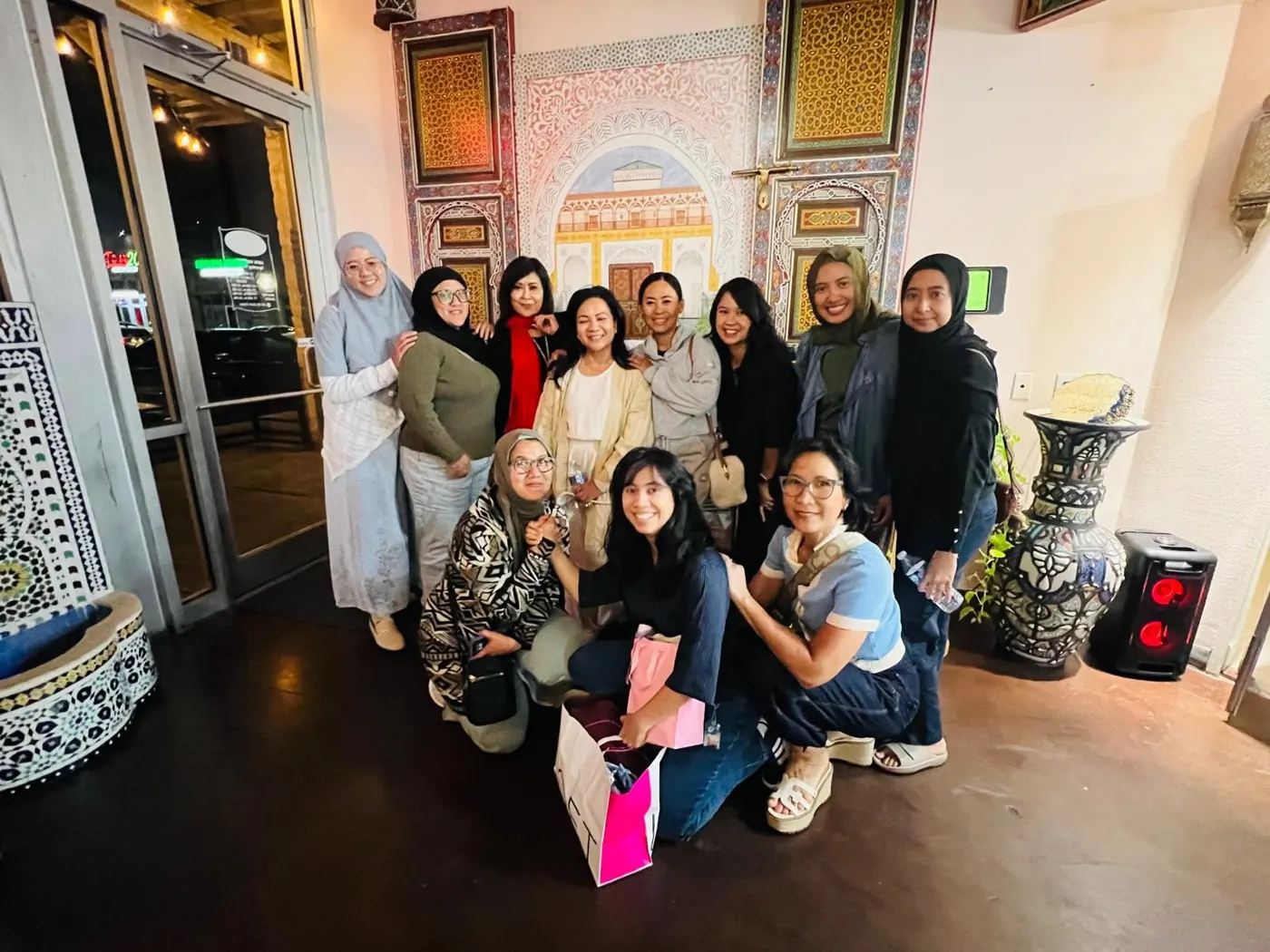 Sisters posing together in a decorated restaurant